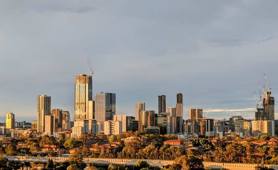 Sunset view of Parramatta skyline showcasing modern skyscrapers and construction cranes in Sydney,